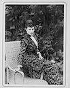 (1890) Dagmar sitting on the armrest of a chair