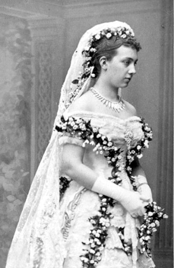 The lavish details of a nineteenth century wedding dress are illustrated by