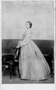 1861 Dona Antonia standing behind chair