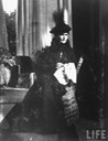 1916 Somber-looking Alexandra Feodorovna, consort of Tsar Nicholas II of Russia, sitting doing needlework a short time after the death of Rasputin