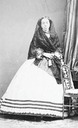 Duquesa de Fernán Núñez standing wearing a cage crinoline and lace shawl