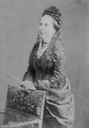 Luisa Fernanda standing wearing a dress with a cuirasse bodice